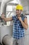 Happy young male worker gesturing thumbs up in industry