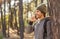 Happy young man backpacker talking on phone while hiking
