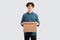 Happy Young Man Holding Cardboard Box Standing Over White Background