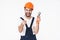 Happy young man holding plumbing wrench pointing to you