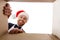 Happy young man looking into open christmas gift