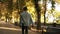 Happy young man riding bike in the park in black headphones. Man with outstretched hands. Enjoyment, hanging outdoors in