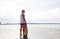 Happy young man with skimboard on summer beach