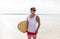 Happy young man with skimboard on summer beach