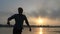 Happy Young Man Turns Around on The River Bank at a Splendid Sunset in Slo-Mo