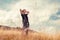 Happy young man walk on golden autumn field