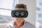 Happy young man wearing virtual reality goggle