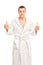 Happy young man in a white bathrobe giving two thumbs up isolate