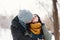 A happy young man and woman kissing in winter enjoying life and