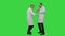 Happy young medical students dancing, celebrating they pass exam on a Green Screen, Chroma Key.