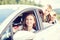 Happy young mom and her children sitting in a car