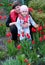 Happy young Mother with baby playing in a field of tulips