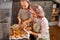 Happy young mother and cute kid daughter bake cookies in kitchen