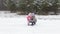 happy young mother plays with her little snow baby in the winter forest