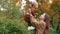Happy young mother toss up her cute cheerful toddler son in the air in the park