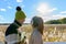 Happy young multi ethnic couple looking at scenic view of autumn bulrush field together