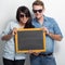 Happy Young Multiculture Couple posing with chalk board