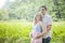 Happy young newly expecting couple portrait outdoors