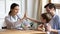 Happy young pediatrician giving high five to small child boy.