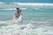 Happy young people embrace and laugh in the waters of the Indian Ocean. Wedding and honeymoon in the tropics on the island