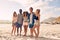 Happy young people enjoying a day at beach