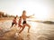 Happy young people having fun at beach on sunny day