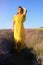 Happy young pretty modest smiling woman enjoying fresh air and aroma at sunset in a lavender field