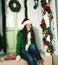 Happy young real american girl at home decorated on Christmas