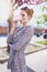 Happy young redhead woman drinking from plastic coffee cup