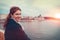 Happy young redhead woman looking back at Budapest cityscape in