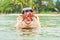 Happy young scuba diver holding sea star, smiling, looking at ca