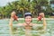 Happy young scuba diver holding sea star, smiling, looking at ca