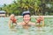 Happy young scuba diver holding sea star, smiling, looking at camera