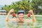 Happy young scuba diver holding sea star, smiling, looking at camera