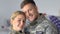 Happy young serviceman and woman looking camera, military couple, american army