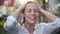 Happy Young Smiling Woman Having Fun In Rainy Weather. Cheerful Lady Has Wet Hair In Summer Park.