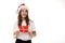 Happy young teenager girl in white t-shirt and santa claus red hat holds gift certificate looking at side on sopt space isolated