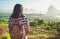 Happy young traveler woman backpacker looking backward to camera