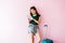 Happy Young Traveler Woman with Suitcase and Music Headphone using Tablet and Smiling, Technology on Traveling, Lifestyle of Mode