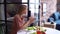 Happy young vegetarian woman uses smartphone for taking photos of vegetables.