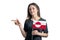 Happy young white woman holding flag Greenland and points to the left isolated on a white background