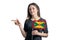 Happy young white woman holding flag Grenada and points to the left isolated on a white background