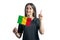 Happy young white woman holding flag of Mali and points thumbs up isolated on a white background