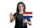 Happy young white woman holding flag of Paraguay and with a serious face shows a hand stop sign isolated on a white background
