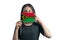 Happy young white woman holding flag Vanuatu flag and covers her face with it isolated on a white background