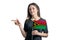 Happy young white woman holding flag Vanuatu and points to the left isolated on a white background