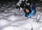 Happy young white woman lies in a snowy snowdrift and smiles, joyful emotions on the girl`s face