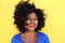 Happy young woman with afro hair smiling