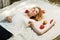 Happy young woman with apples lying on the cover