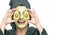 Happy young woman with avocado facial mask